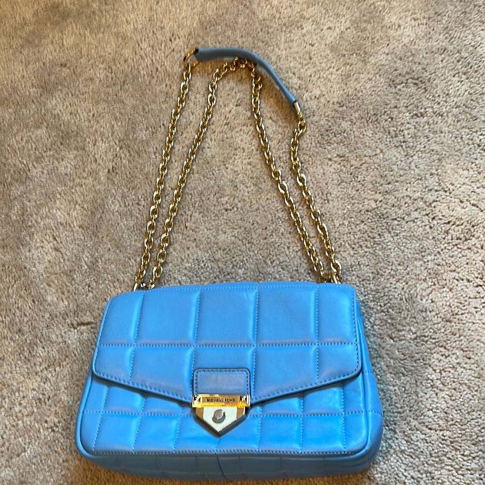 Michael Kors blue handbag with a gold chain